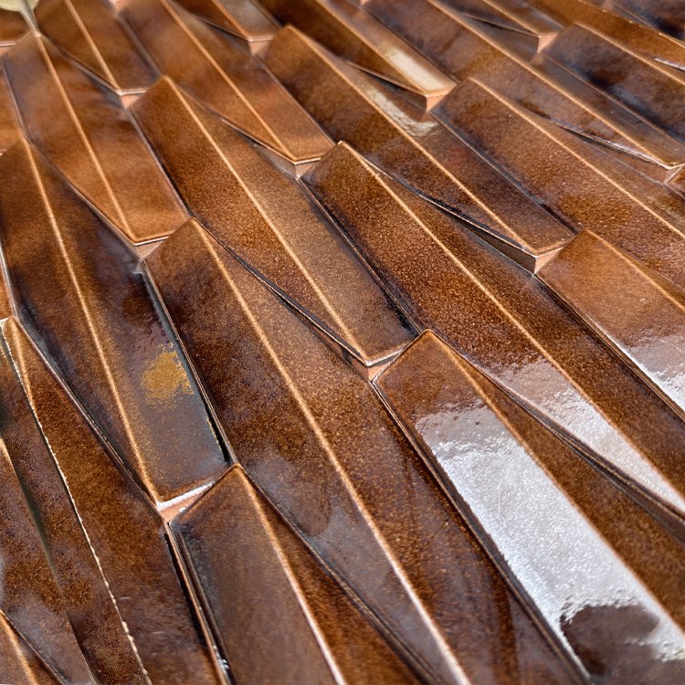 Zuma dimensional tile in a glossy brown glaze
